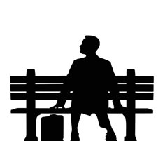 the silhouette of a man sitting on a bench