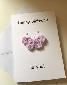 a birthday card with a pink crocheted butterfly on it and the words happy birthday to you