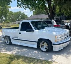 a white pickup truck parked in a driveway