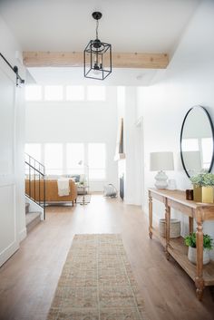 a living room with wood floors and white walls