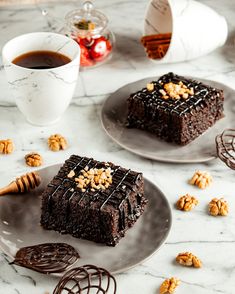 two plates with brownies and nuts on them