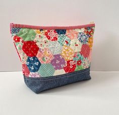 a colorful patchwork purse sitting on top of a white table