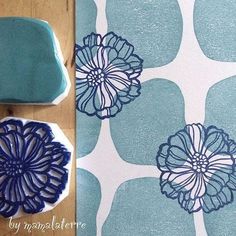 a blue and white flower design is next to a cookie