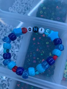 a close up of a plastic container with beads and letters on the inside of it