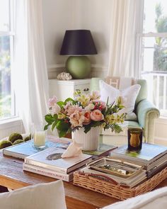 a coffee table with flowers and books on it