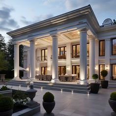 a large white house with columns and lights