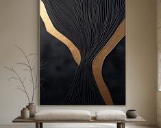 a large black and gold painting in a living room