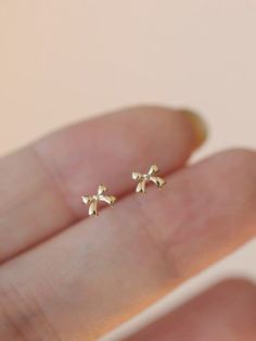 Spoil her with these exquisite 10k solid gold mini bow stud earrings. Adorned with sparkling CZ stones, they're delicate and stunning. Each piece is handcrafted in our U.S. studio and arrives in a beautiful gift box. Personalization options available. Aesthetic Stud Earrings, Bow Stud Earrings, Cute Jewelry Gold, Now Earrings, Gold Bow Earrings, Cute Dainty Jewelry, Cute Simple Earrings, Cute Gold Earrings, Gold Earrings Aesthetic