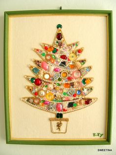 a christmas tree made out of buttons in a green frame