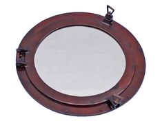 an old porthole mirror on a white background