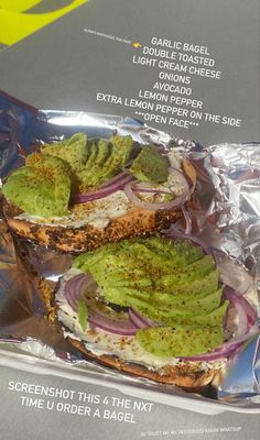 the sandwich is wrapped in aluminum foil and has avocado on it's side