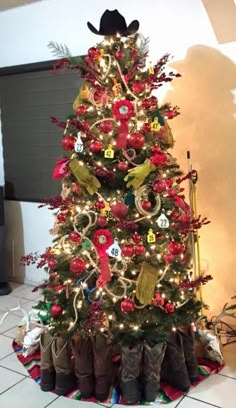 a christmas tree decorated with cowboy boots and ornaments