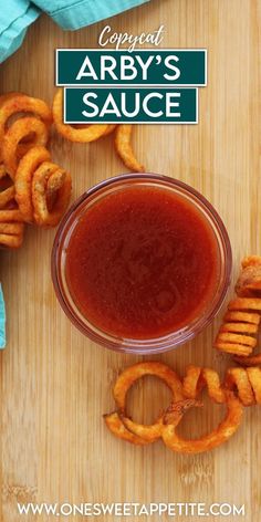 an overhead view of a sauce in a bowl surrounded by onion rings