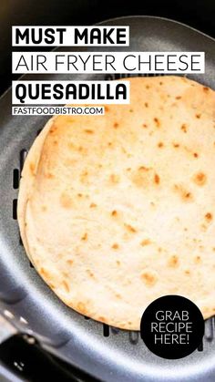 an air fryer with a tortilla in it and the words must make air fryer cheese quesadilla