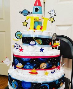 a multi layer cake decorated with space and stars