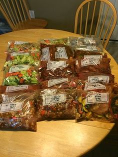 several bags of food sitting on top of a wooden table