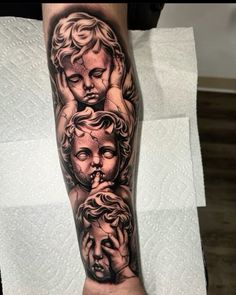 a woman's leg with tattoos on it and an image of two cherubs