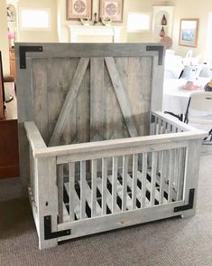 a baby crib made out of wood with an open door on the top and bottom