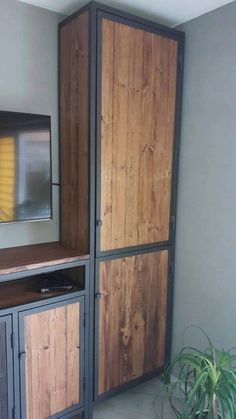 an entertainment center with wood paneling and metal doors