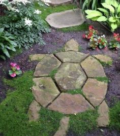 a stone path in the middle of a garden