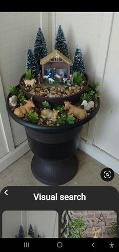 there is a potted planter with rocks and fake animals in the center on it