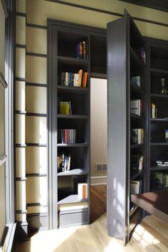 an open bookcase in the corner of a room