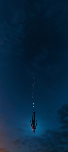 a person diving into the water at night