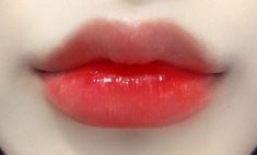 a woman's lips with bright red lipstick