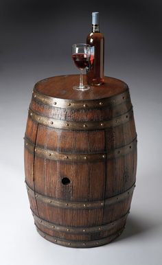 a wine glass sitting on top of a wooden barrel