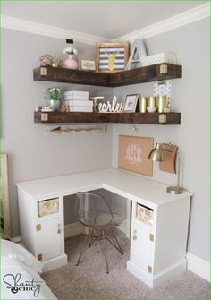 a white desk with shelves above it and some pictures on the wall in front of it