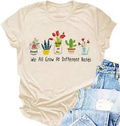 a t - shirt that says we all grow at different kates on the front