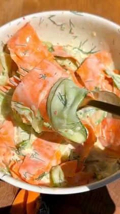 a person cutting up some food in a bowl