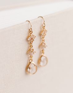 "✨Designed specifically for your special day, but can be worn on any occasion!✨ Beautifully accent any wedding dress or date night outfit with our Rainfall Earrings! Perfectly sparkly with just the right amount of class. These earrings are hypoallergenic and feature a 14k Gold Filled hook with Gold Plated cubic zirconia and vintage glass accents. Earrings measure approx. 1.6\" x .3\" Thank you so much for shopping with GGC! By supporting a small business, you are supporting a dream, a family, and so much more! We are so grateful for you! We hope to create with you again soon! ✨LOOKING FOR MORE EARRINGS?✨ Check out our other listings here: https://www.etsy.com/shop/GoldenGratitudeCol?ref=simple-shop-header-name&listing_id=1157209858§ion_id=37356619"