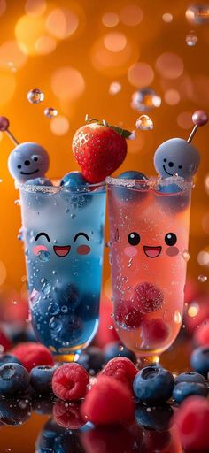 two glasses filled with liquid next to berries