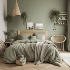 a bedroom with green walls and wooden flooring is pictured in this image, there are plants on the wall above the bed