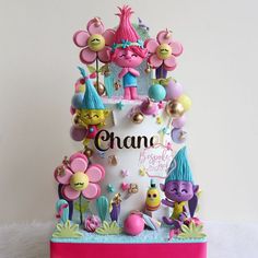 a birthday cake decorated with cartoon characters and decorations