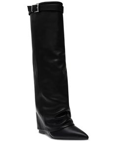 Stay up with the latest trends with the Corenne Black Boot by Steve Madden. Tall cuffed shafts blend with buckles and sleek wedges for a fresh update to your boot collection. Pair it with your favorite skirt or dress to take your look from day to night. Composition and Fit 4" wedge heel Shaft height: 17"; Circumference: 15"; measured on a size 6 Pointed toe Functional inside zip Cuffed shaft and buckled strap detail NOTE: Shaft height and circumference vary by size. Leather upper; manmade lining Steve Madden Kameron Boots, Black Knee-high Platform Boots With Rivets, Black Wide Calf Mid-calf Boots With Buckle Closure, Black Wide Calf Knee-high Boots With Buckle Closure, Boot Collection, Black Knee-high Boots With Zipper Closure, Black Knee-high Moto Boots With Zipper Closure, Boot Cuffs, Wedge Heels