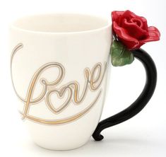 a white coffee cup with a red rose in the middle and love written on it