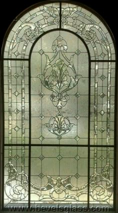 an ornate stained glass window with flowers and leaves