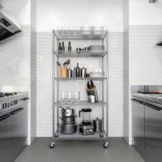 an industrial style kitchen with stainless steel shelving and white tiled walls, along with silver appliances