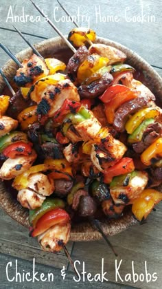 chicken and steak kabobs on skewers in a bowl with text overlay