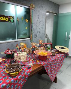 a table filled with lots of food next to a window