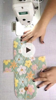 someone is using a sewing machine to sew flowers