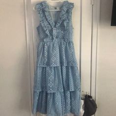 Nwt, Never Been Worn, Beautiful Midi Dress. Light Blue, Eyelet Detail, Three Tiered With Ruffles Down Chest. Zip Enclosure On Back. Light Blue Tiered Dress With Ruffles, Blue Ruffled Midi Dress, Blue Ruffled Midi Dress For Spring, Light Blue Ruffled Midi Dress For Garden Party, Blue Sleeveless Midi Dress With Ruffles, Blue Ruffled Midi Dress For Brunch, Feminine Blue Tiered Midi Dress, Blue Tiered Lace Dress, Feminine Blue Ruffled Dresses