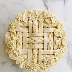 an intricately designed pie crust on a marble surface