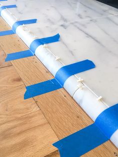 blue and white tape is taped around the edge of a counter top to create an interesting pattern