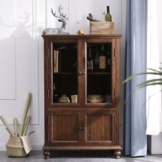 a wooden cabinet sitting next to a window