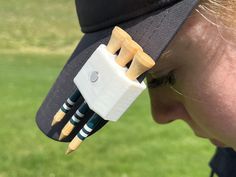 a woman wearing a hat with wooden sticks sticking out of it