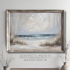 a painting hanging on the wall next to two vases with flowers in them and an ocean view