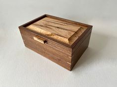 a wooden box sitting on top of a white table